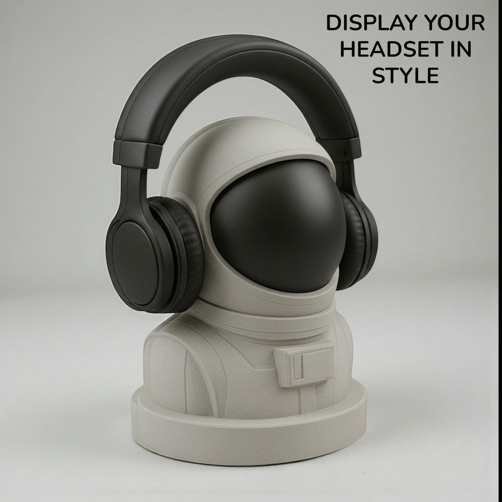 Happy3dWorld white and black 3D printed astronaut headphone stand holding black over-ear headphones on a desk
