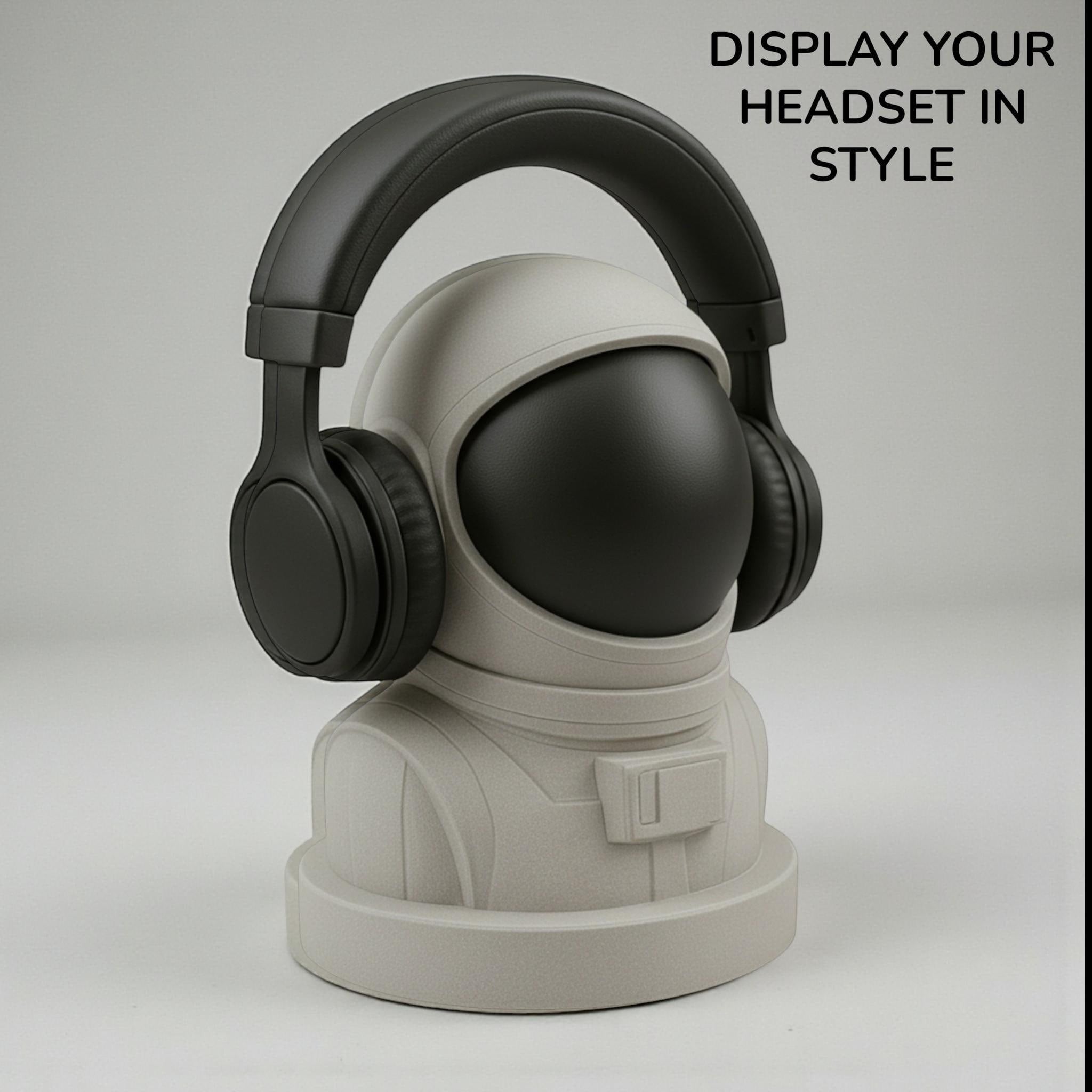 Happy3dWorld white and black 3D printed astronaut headphone stand holding black over-ear headphones on a desk