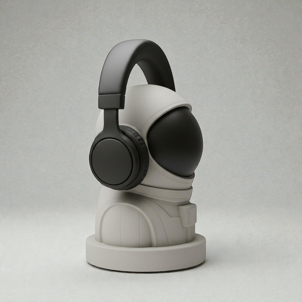 Happy3dWorld white and black 3D printed astronaut headphone stand holding a black headset on a neutral background