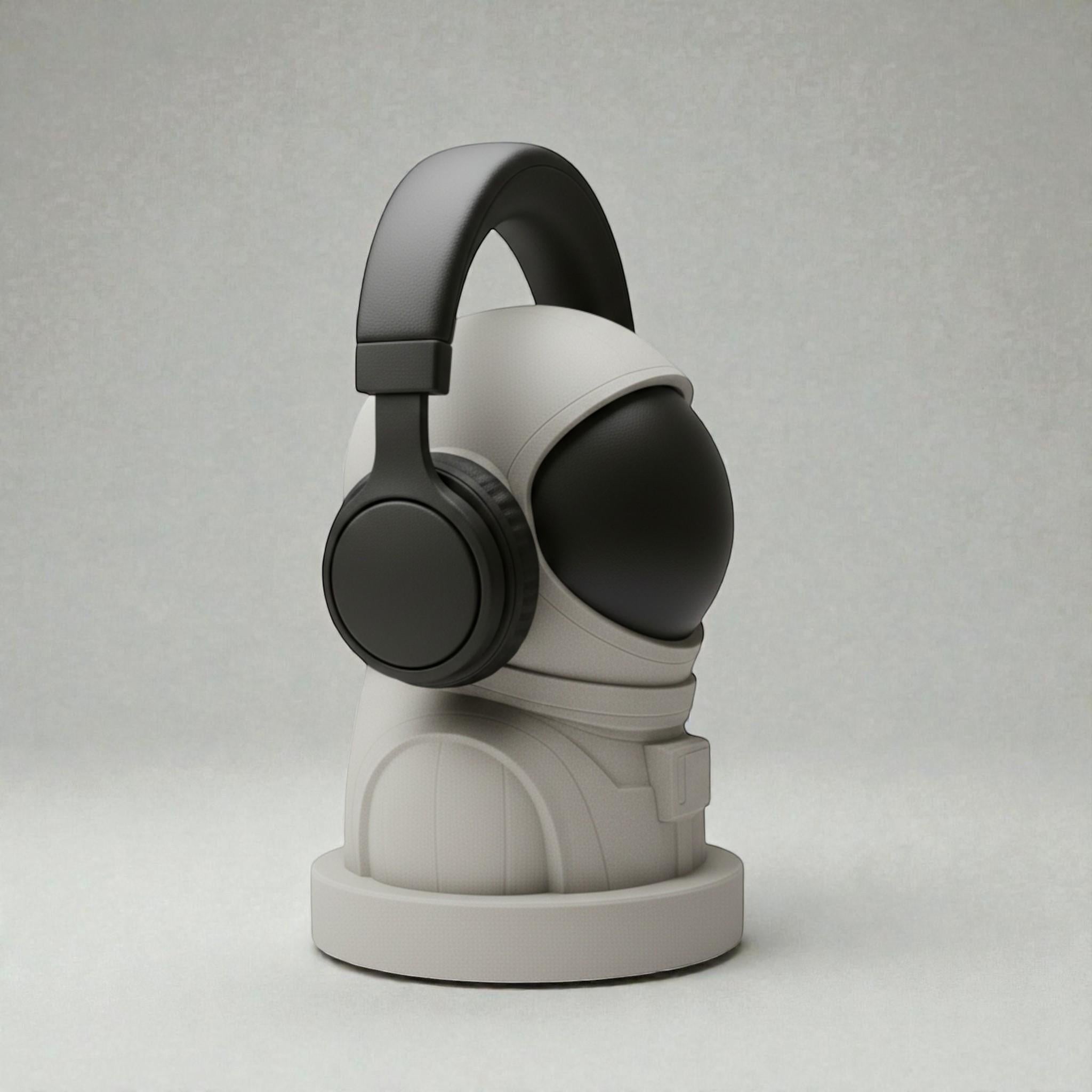 Happy3dWorld white and black 3D printed astronaut headphone stand holding a black headset on a neutral background