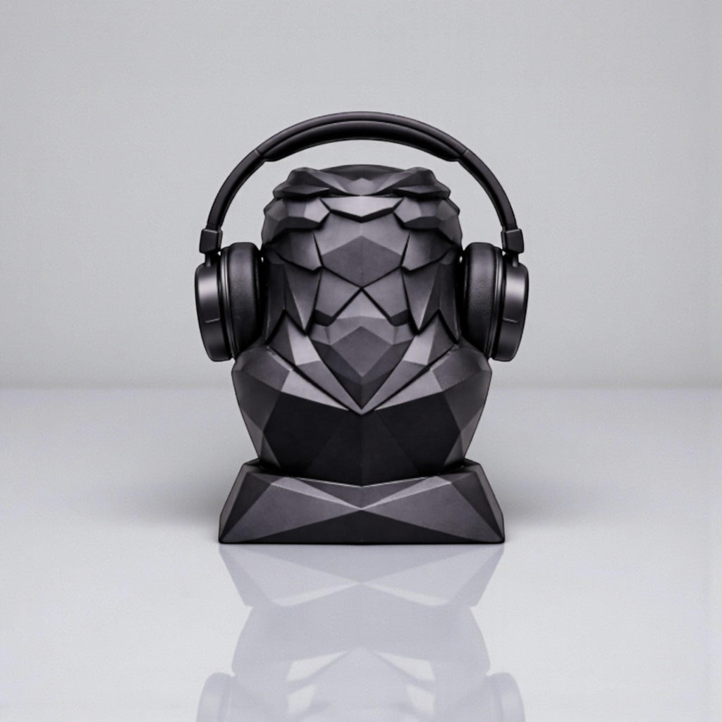 Happy3dWorld black geometric eagle headphone stand with a matte low-poly finish holding over-ear headphones.