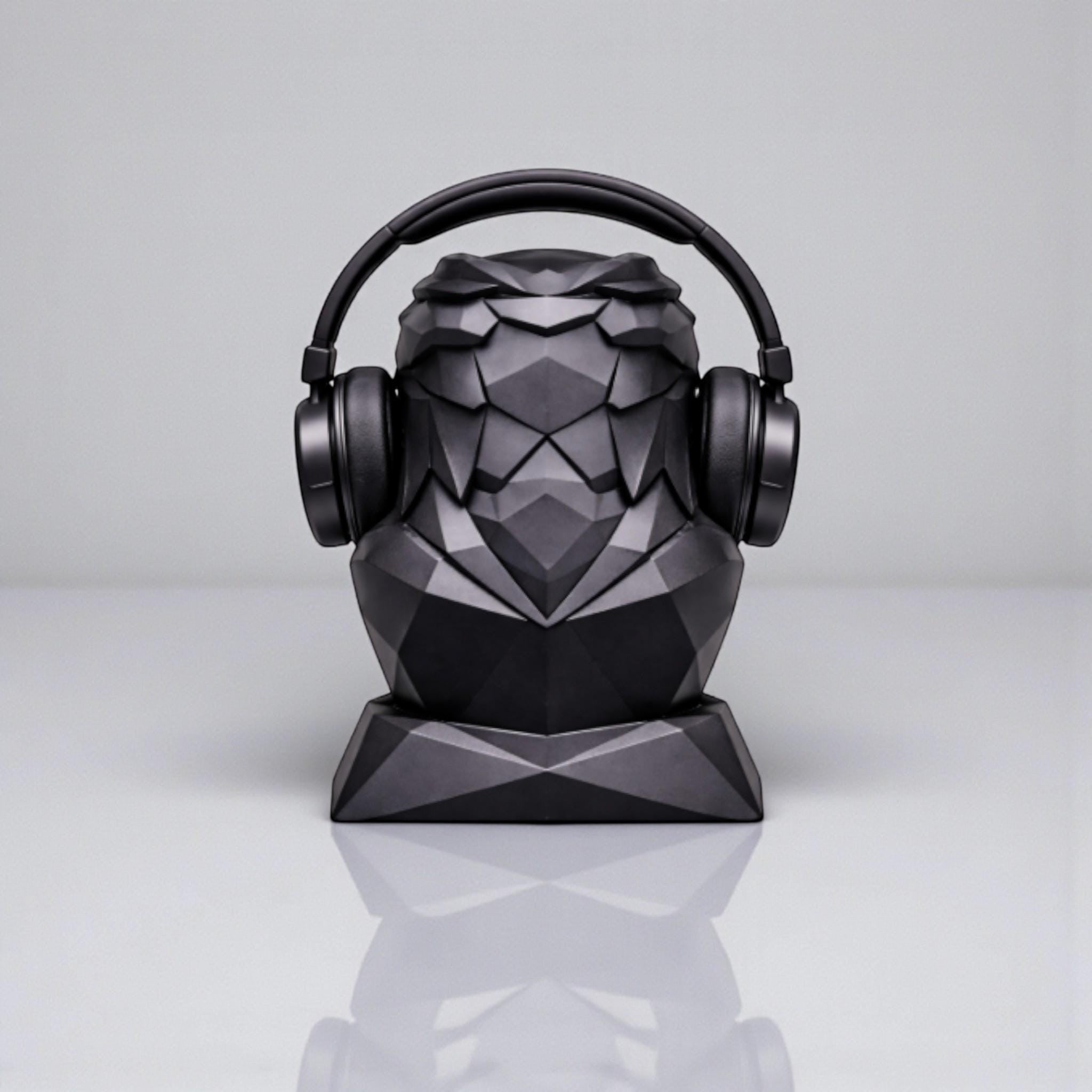 Happy3dWorld black geometric eagle headphone stand with a matte low-poly finish holding over-ear headphones.
