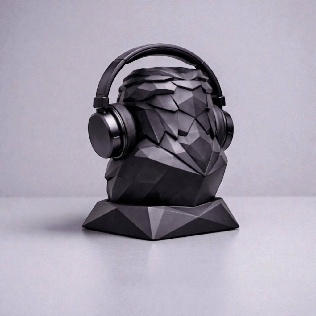 Happy3dWorld matte black geometric eagle headphone stand with a low-poly faceted design holding black headphones.