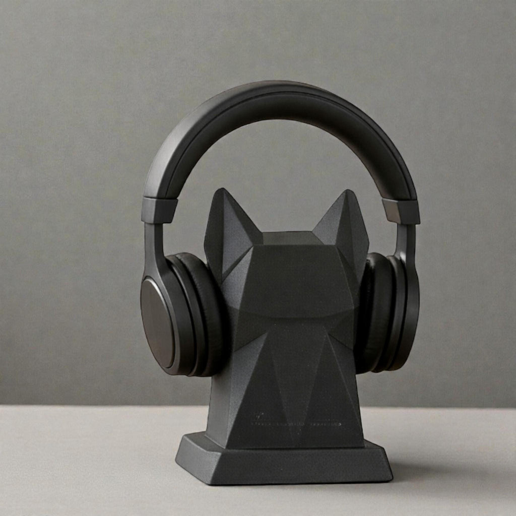 Happy3dWorld black geometric dog headphone stand with a low-poly origami design holding black over-ear headphones.