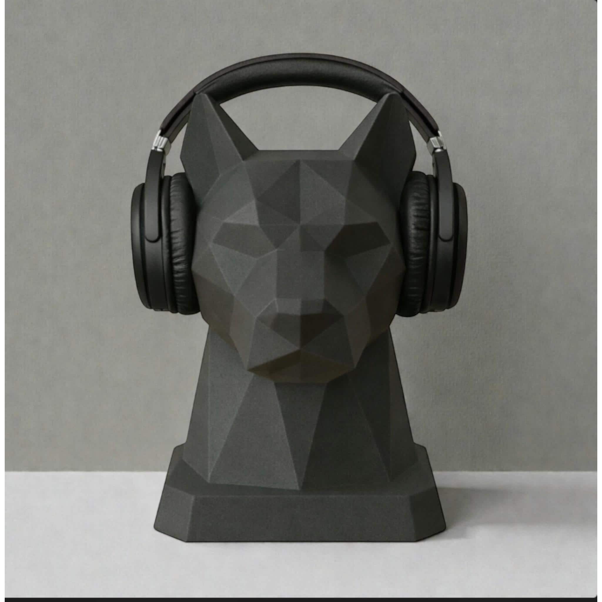Happy3dWorld black geometric dog headphone stand with a low-poly origami design holding black over-ear headphones.