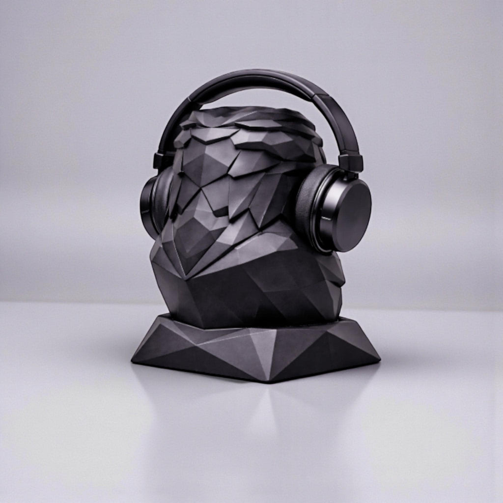 Happy3dWorld black matte geometric low-poly eagle bust headphone stand holding over-ear headphones on a desk
