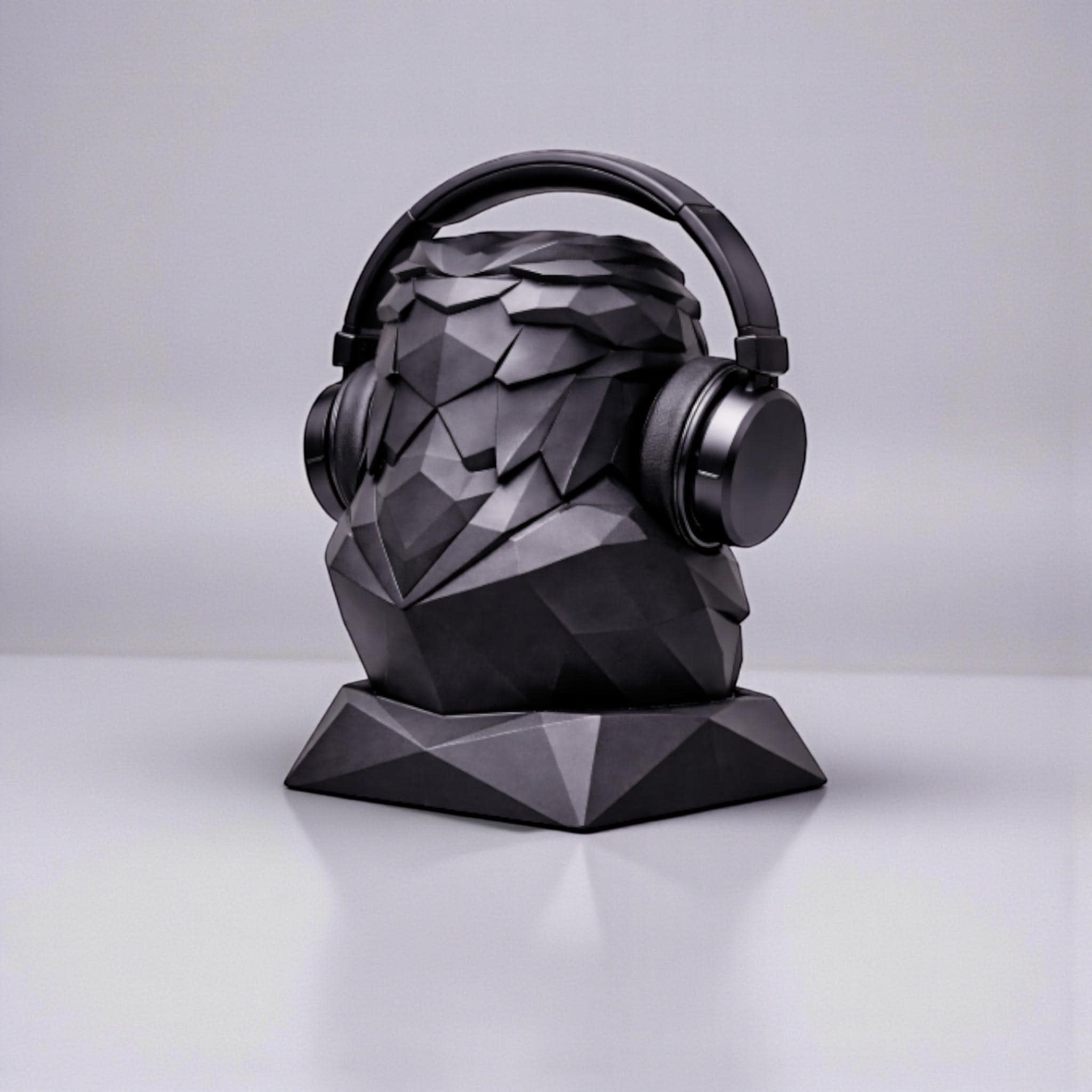 Happy3dWorld black matte geometric low-poly eagle bust headphone stand holding over-ear headphones on a desk