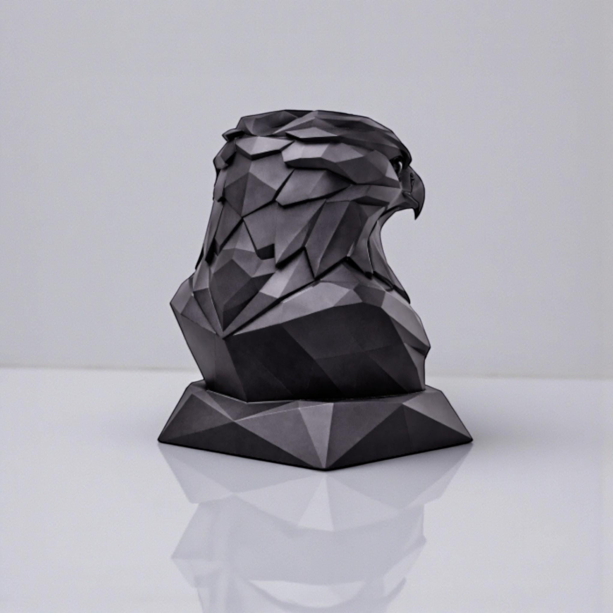 Happy3dWorld black matte 3D printed geometric eagle headphone stand with a low-poly faceted design on a white surface.