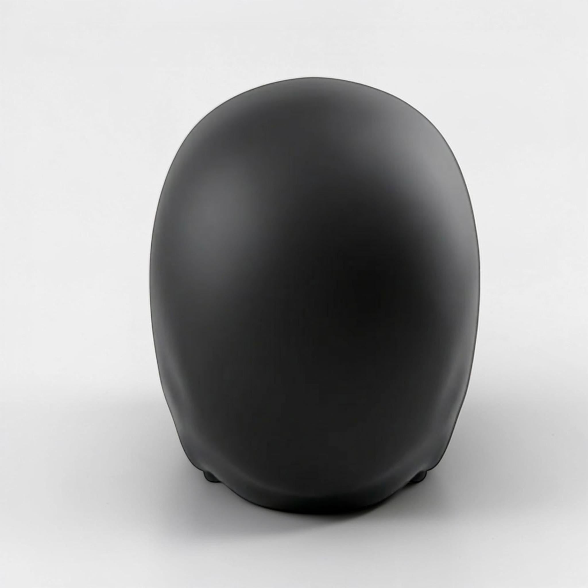 Happy3dWorld black low-polygon skull headphone stand viewed from the back on a white background.