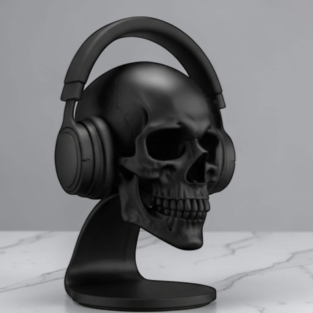 Happy3dWorld matte black anatomical skull headset stand holding over-ear headphones on a marble desk surface