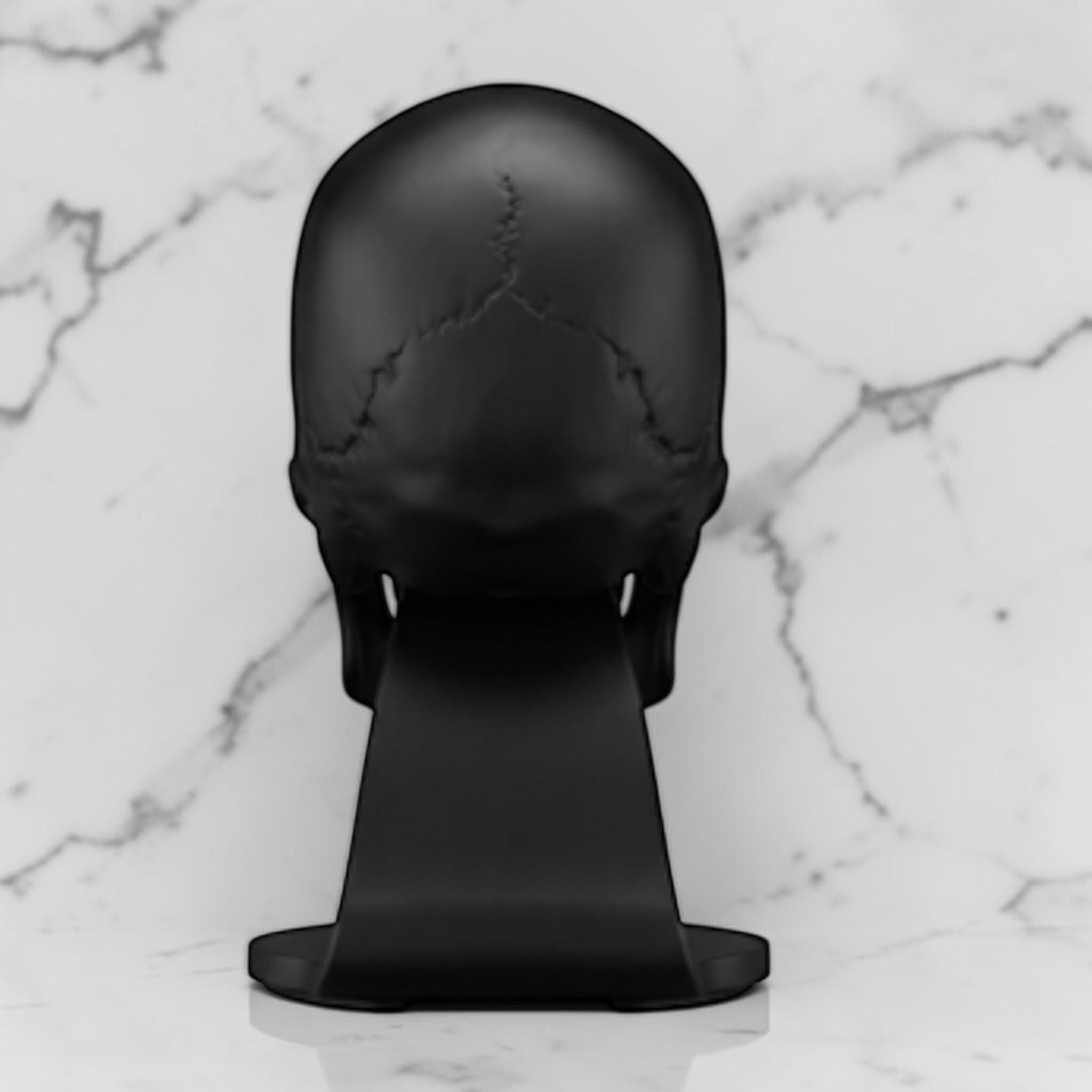 Happy3dWorld matte black anatomical skull headset stand for gaming desks on a white marble background