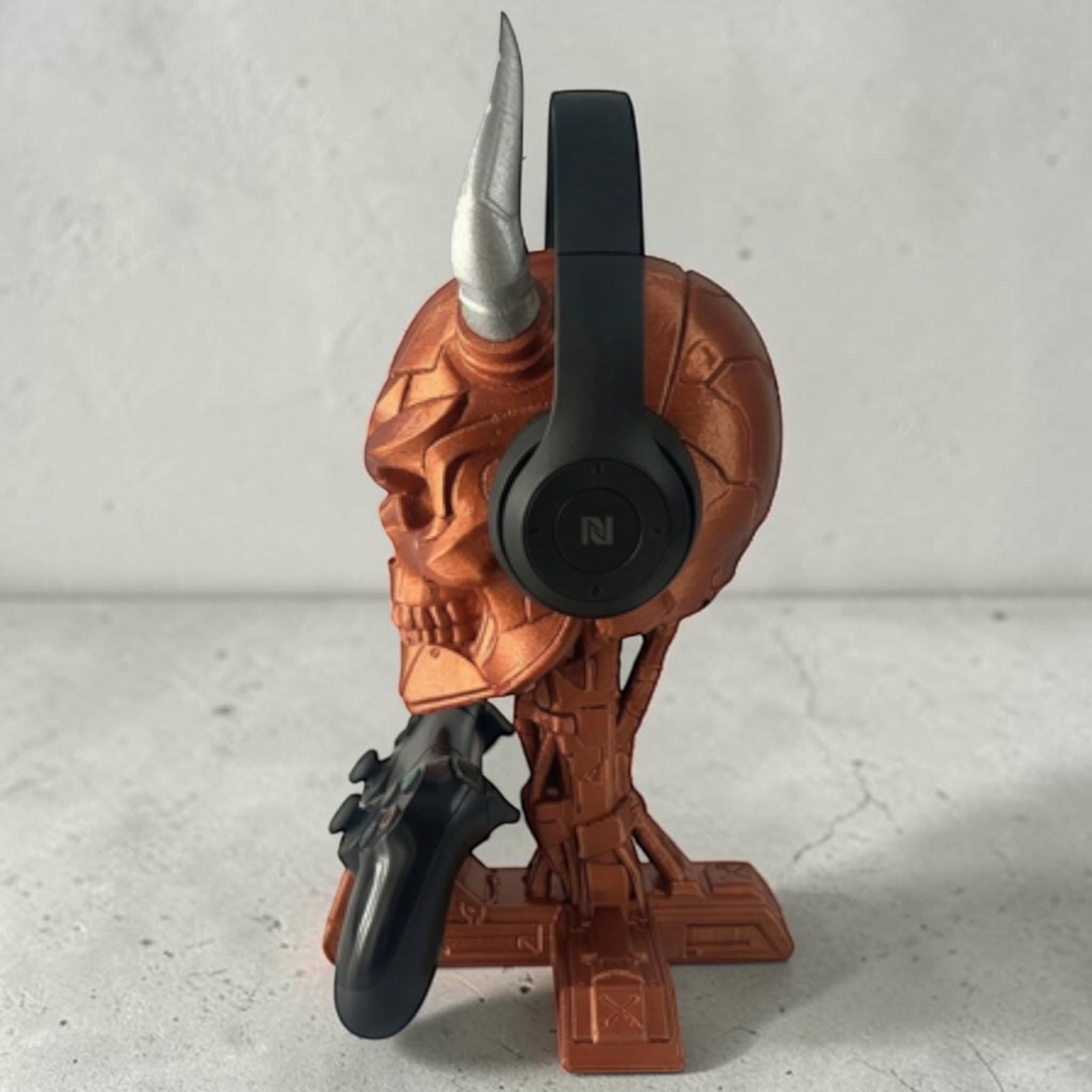 Happy3dWorld cyberpunk skull headset and controller stand in metallic copper with a silver horn on a white surface.