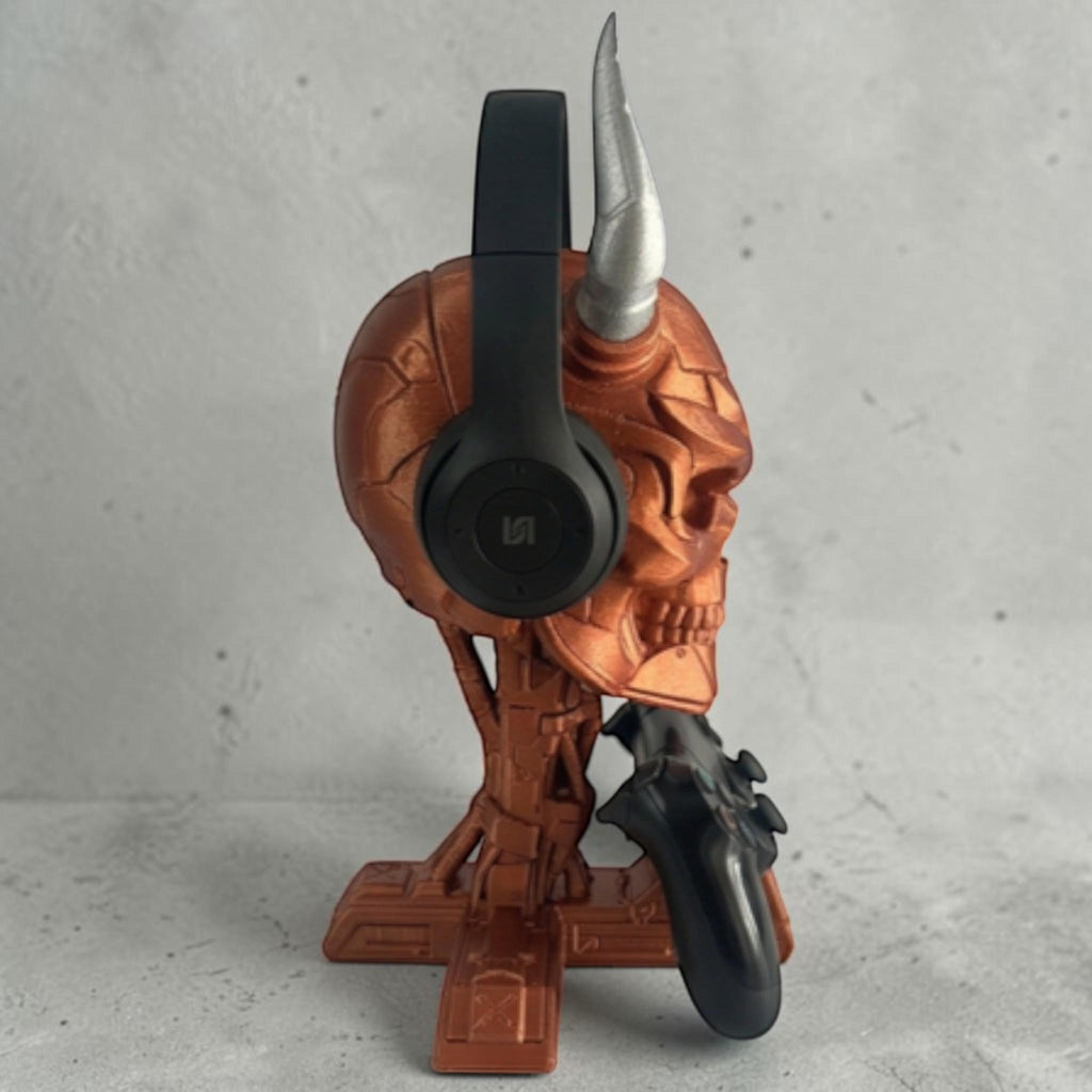 Happy3dWorld cyberpunk skull headset and controller stand in copper PLA with a silver horn holding gaming gear.
