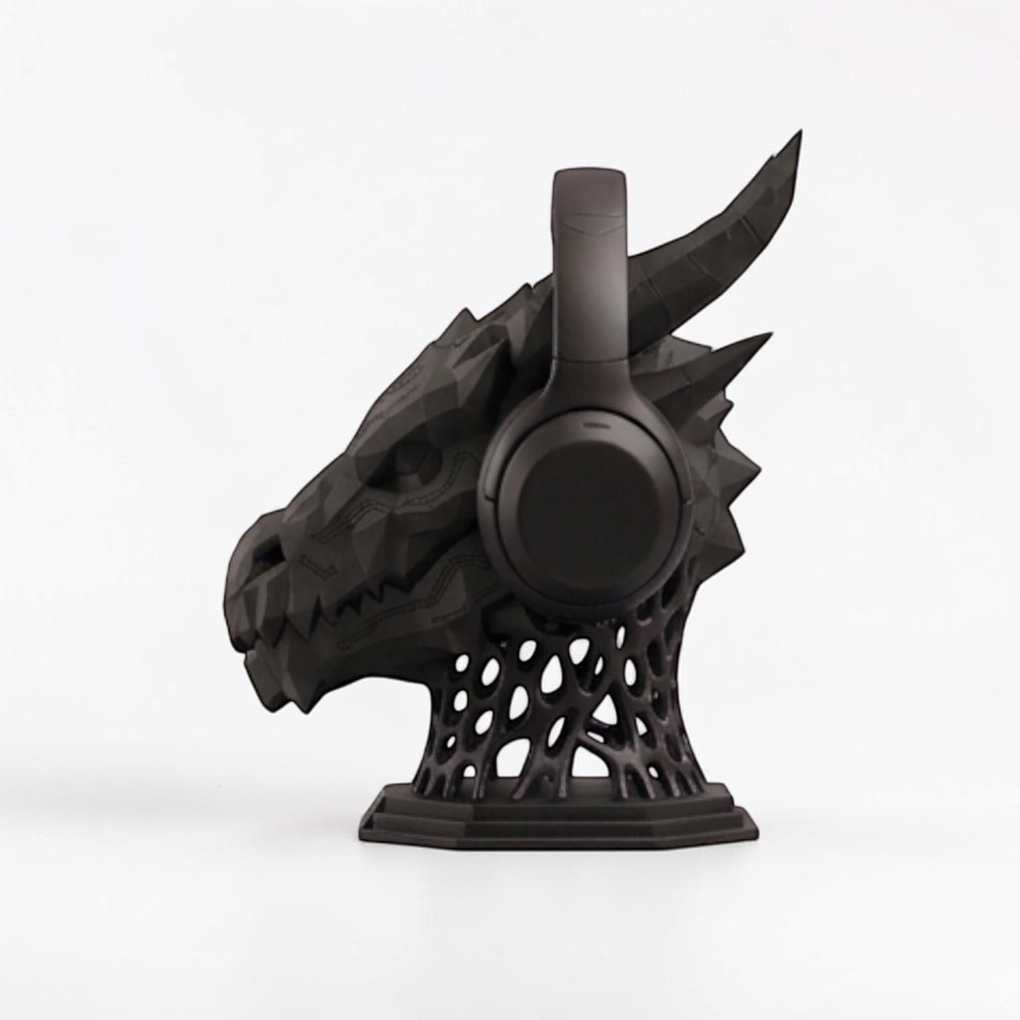 Happy3dWorld matte black 3D printed dragon headset stand with geometric sci-fi design and lattice base.