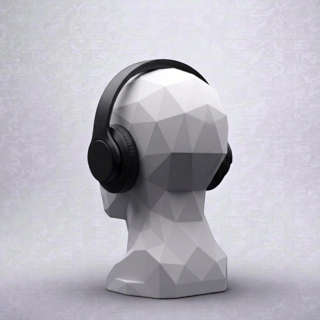 Happy3dWorld minimalist white geometric human bust headphone stand displaying black over-ear headphones on a desk.
