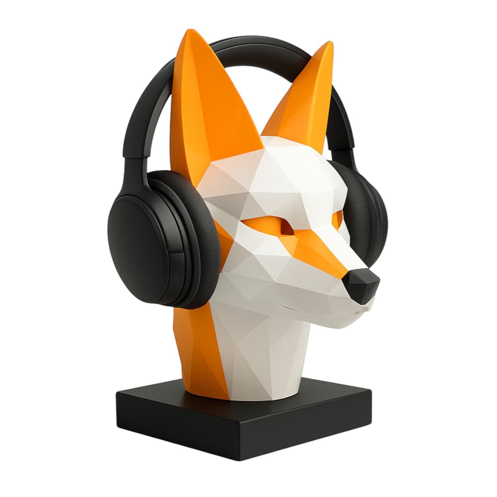 Happy3dWorld low-poly geometric fox headphone stand in orange and white PLA, holding black over-ear headphones.