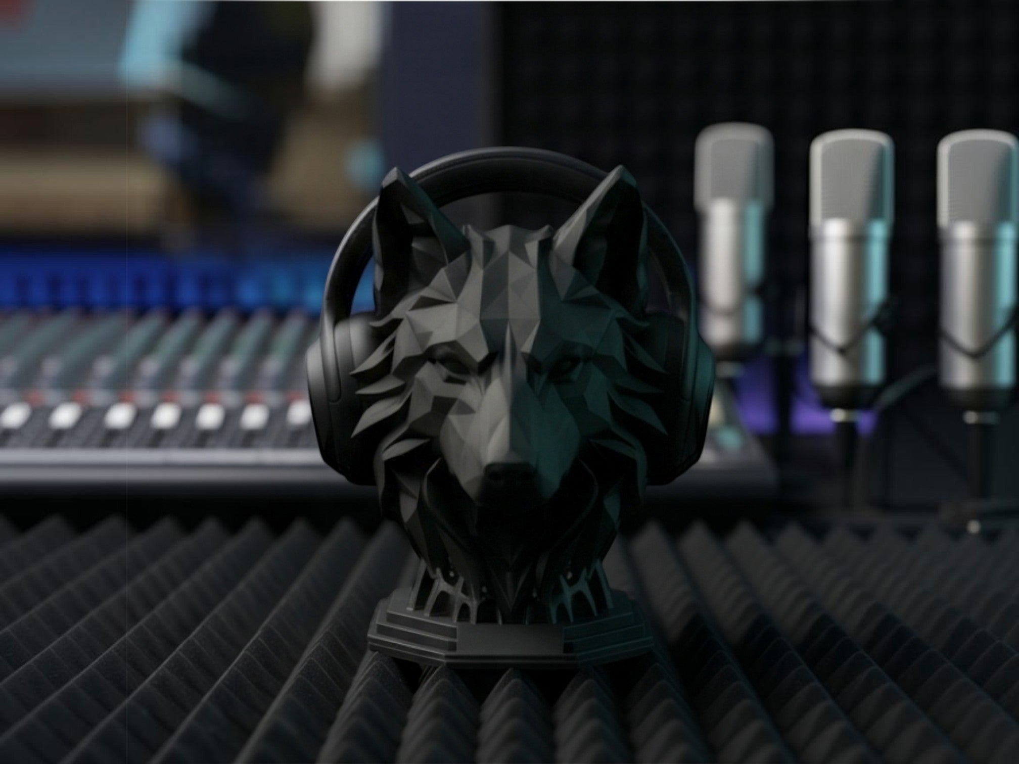 Happy3dWorld matte black geometric wolf headphone stand on a studio desk with audio equipment in the background