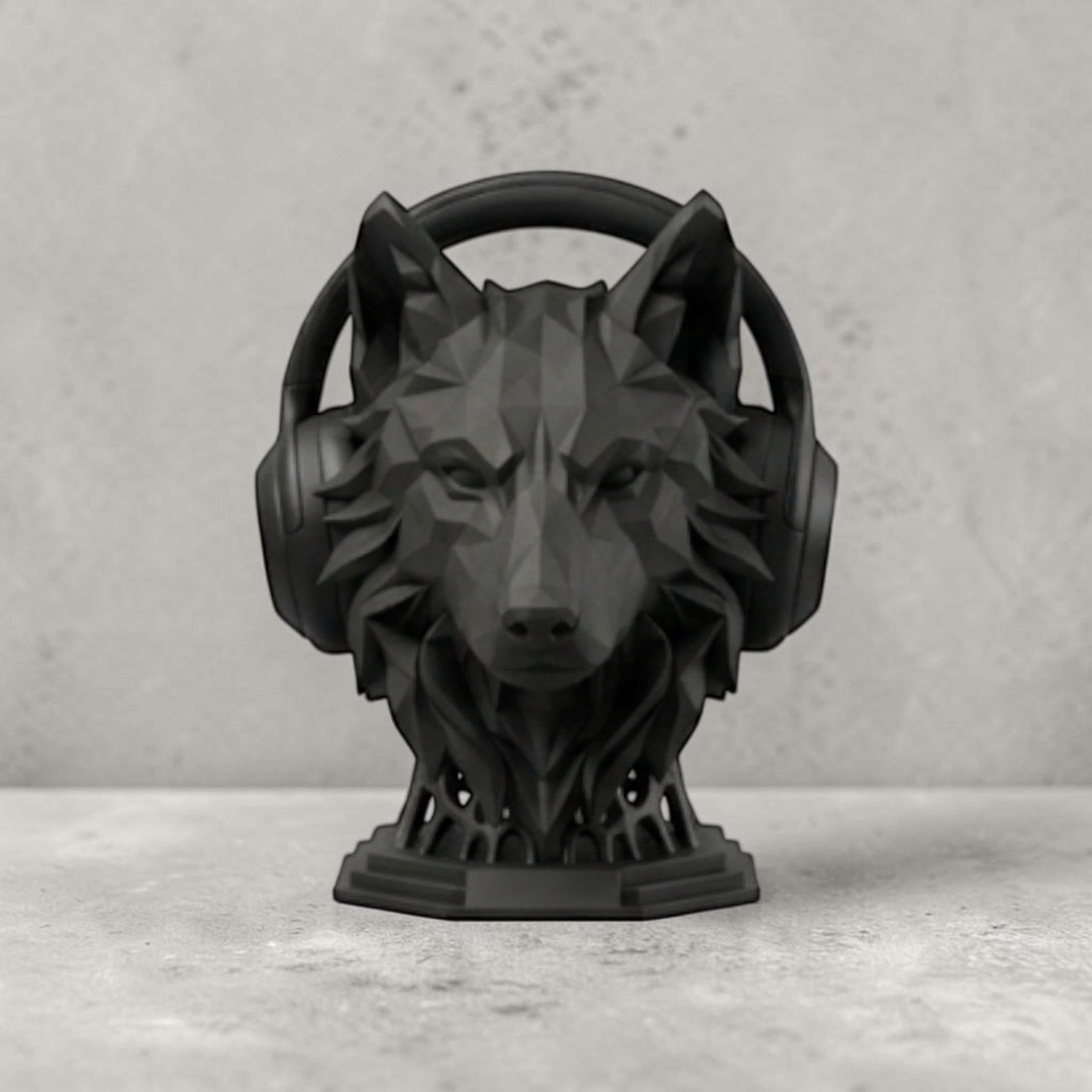 Happy3dWorld matte black geometric wolf headphone stand with a low-poly design on a grey desk surface.