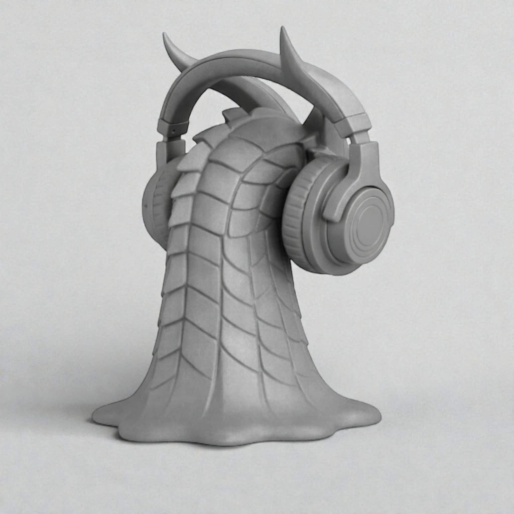 Happy3dWorld gray 3D printed dragon head headphone stand with intricate scales and horns holding over-ear headphones.