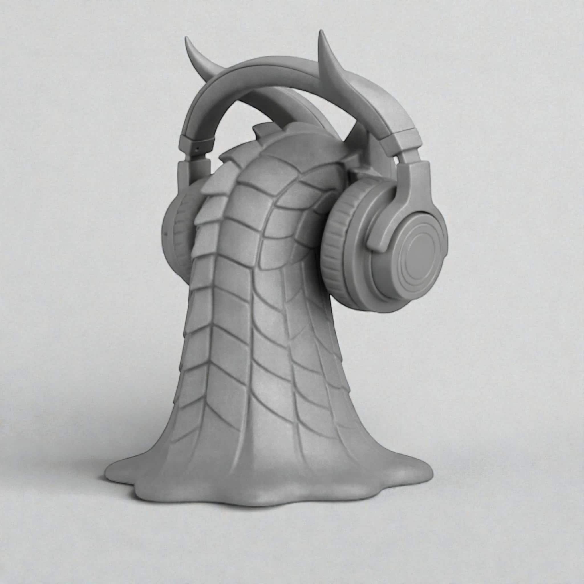 Happy3dWorld gray 3D printed dragon head headphone stand with intricate scales and horns holding over-ear headphones.