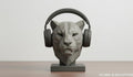 Happy3dWorld gray low-poly geometric tiger headphone stand holding over-ear headphones on a wooden desk.