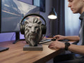 Happy3dWorld gray low-poly lion bust headphone stand on a wooden desk in a modern gaming setup