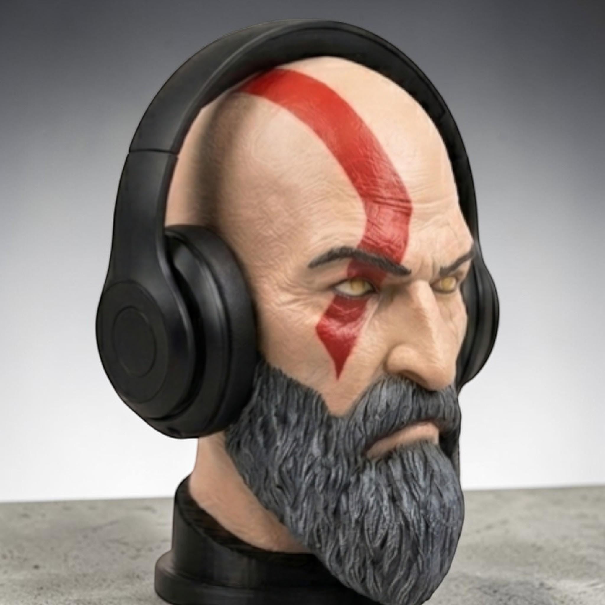 Happy3dWorld Kratos headset stand featuring a detailed 3D printed God of War bust with a black gaming headset.