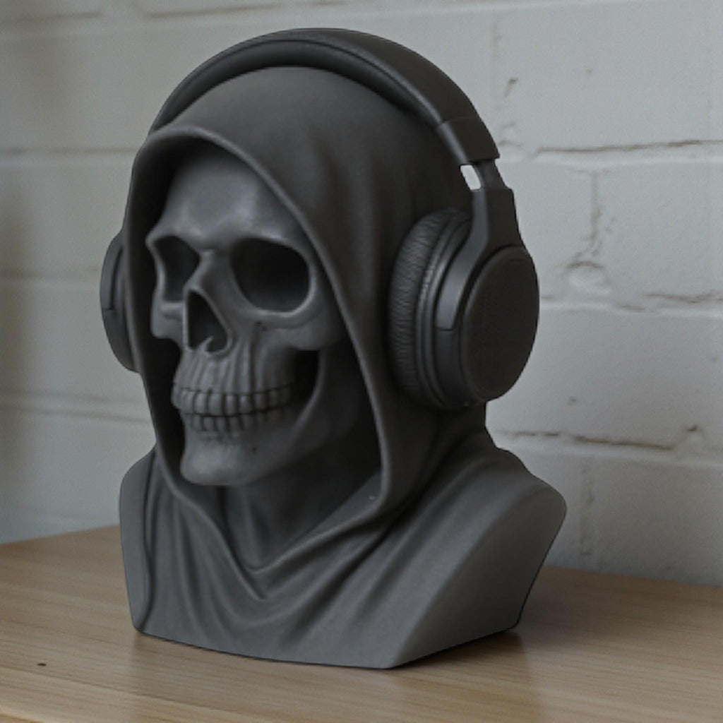 Happy3dWorld matte black death angel skull headphone stand with a hooded design on a wooden desk