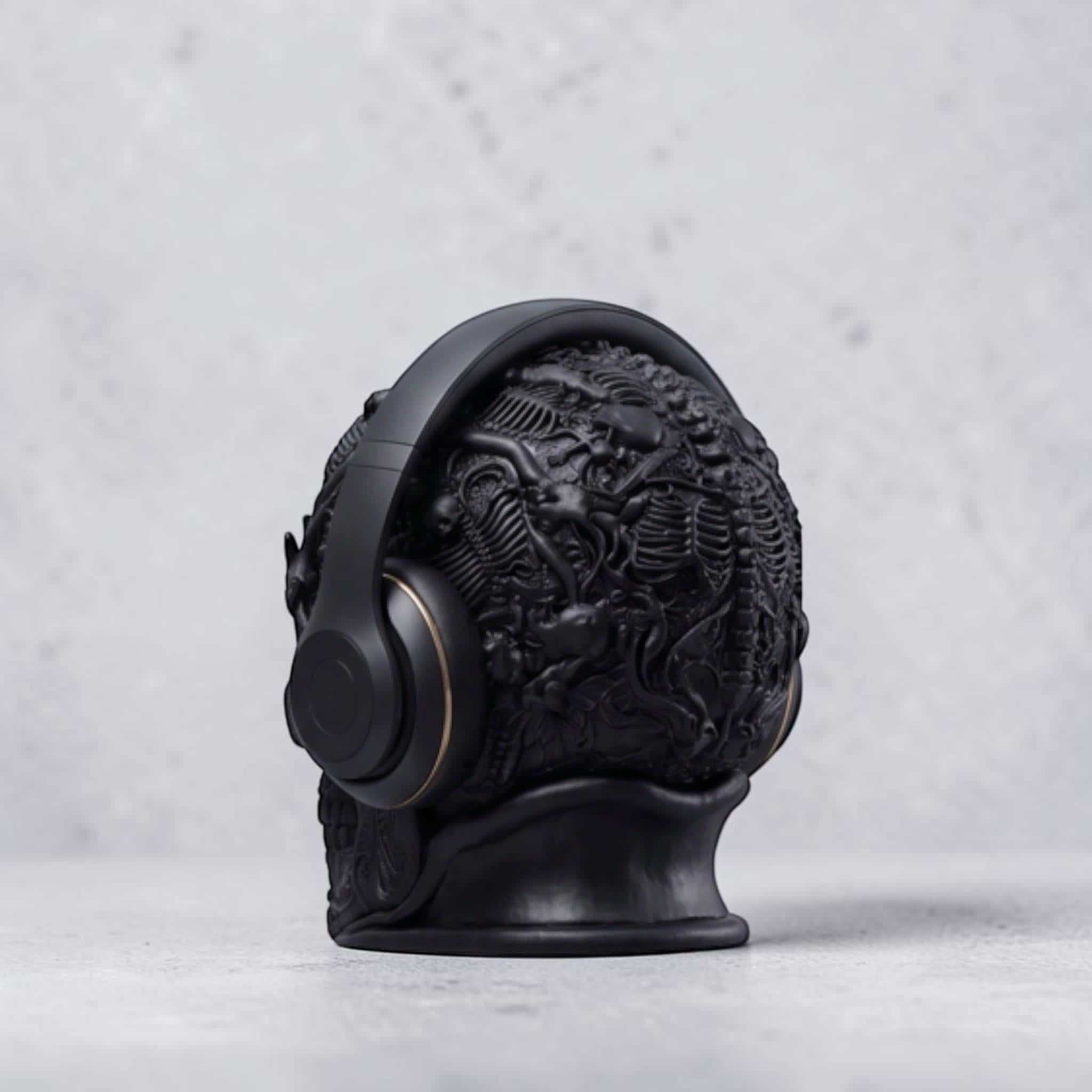 Happy3dWorld matte black gothic skull headphone stand with intricate baroque textures holding over-ear headphones.