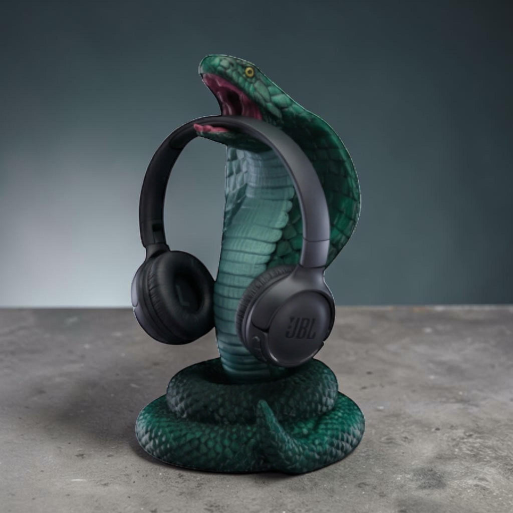 Happy3dWorld metallic green 3D printed cobra headphone stand with detailed scales holding black over-ear headphones.