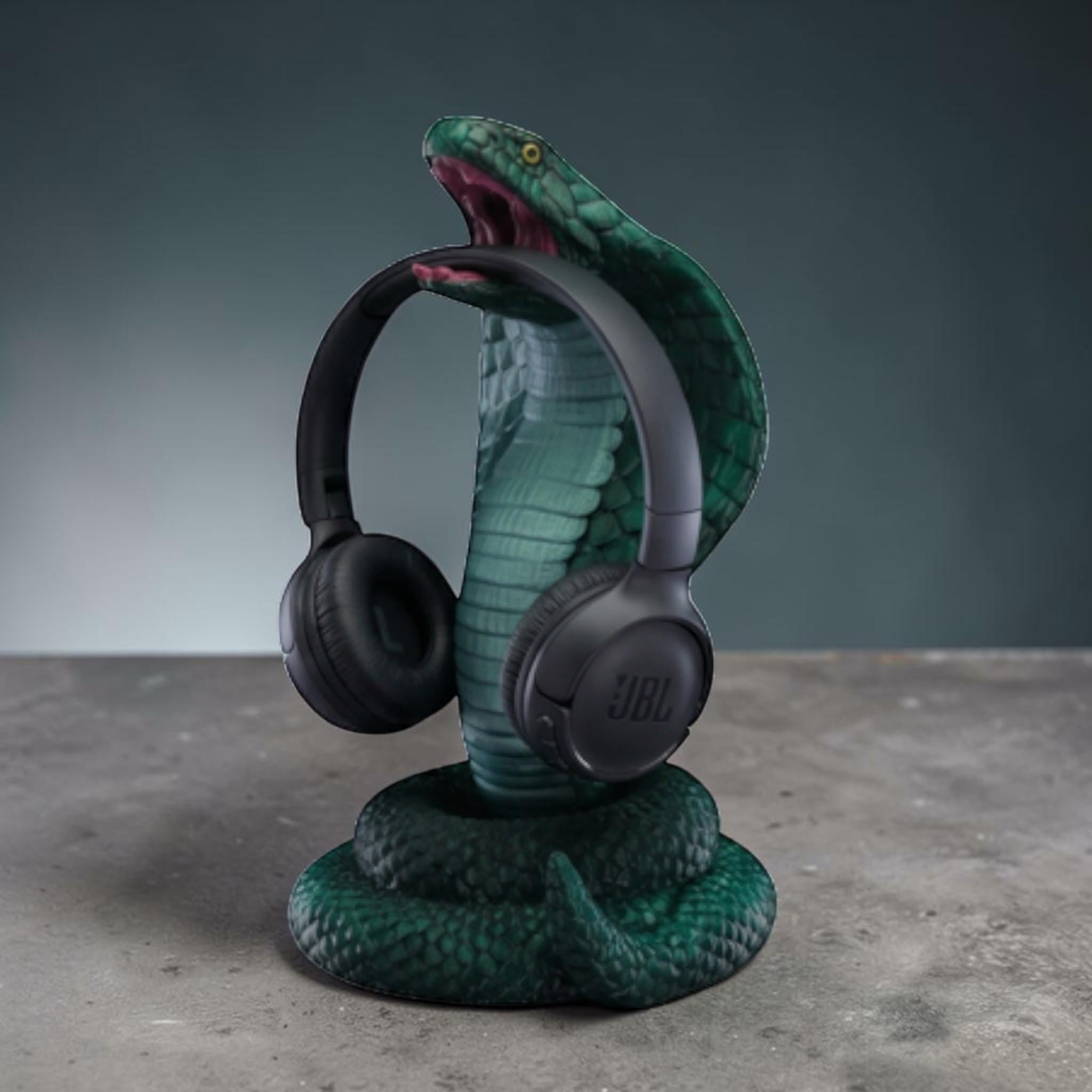 Happy3dWorld metallic green 3D printed cobra headphone stand with detailed scales holding black over-ear headphones.