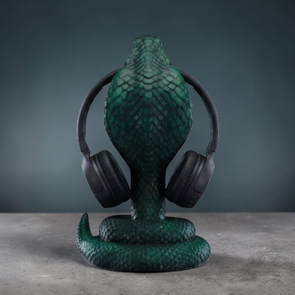 Happy3dWorld metallic green 3D printed cobra snake headphone stand with detailed scales holding black headphones.