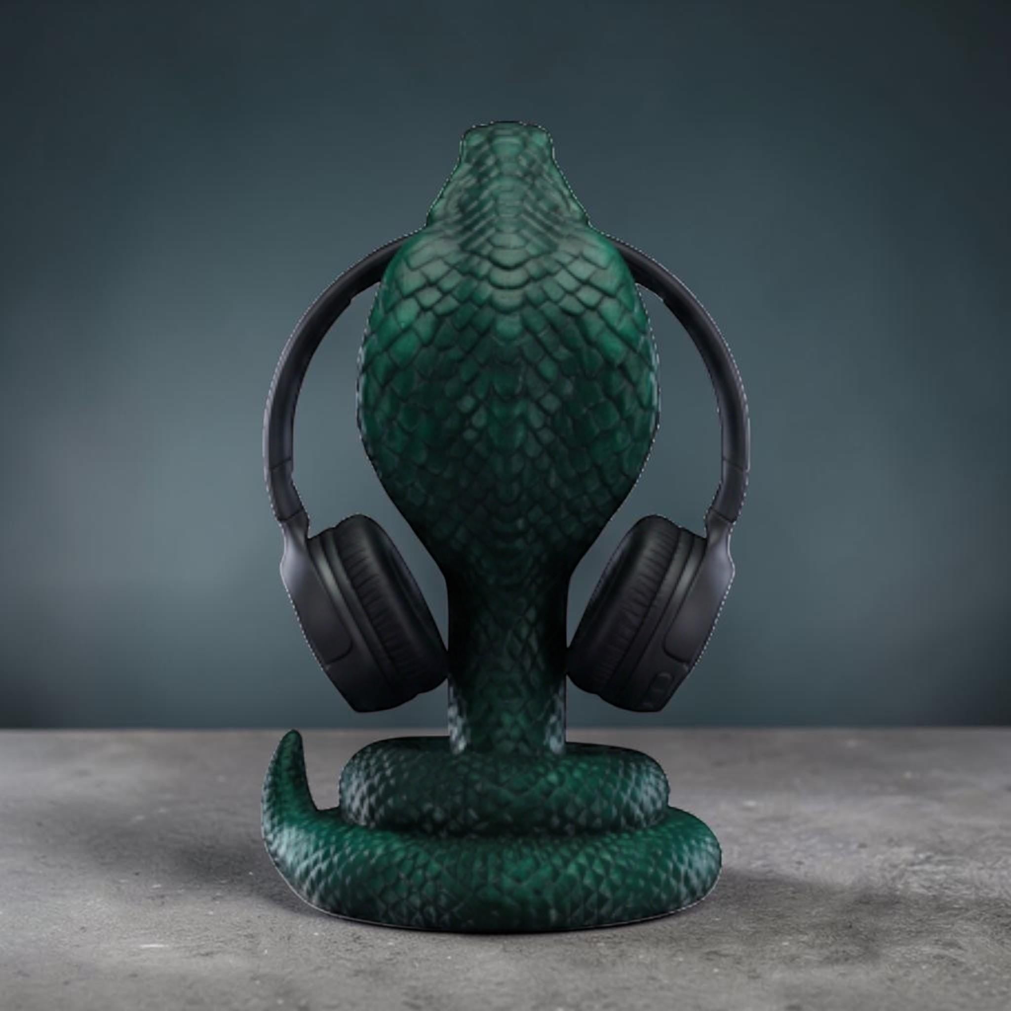 Happy3dWorld metallic green 3D printed cobra snake headphone stand with detailed scales holding black headphones.