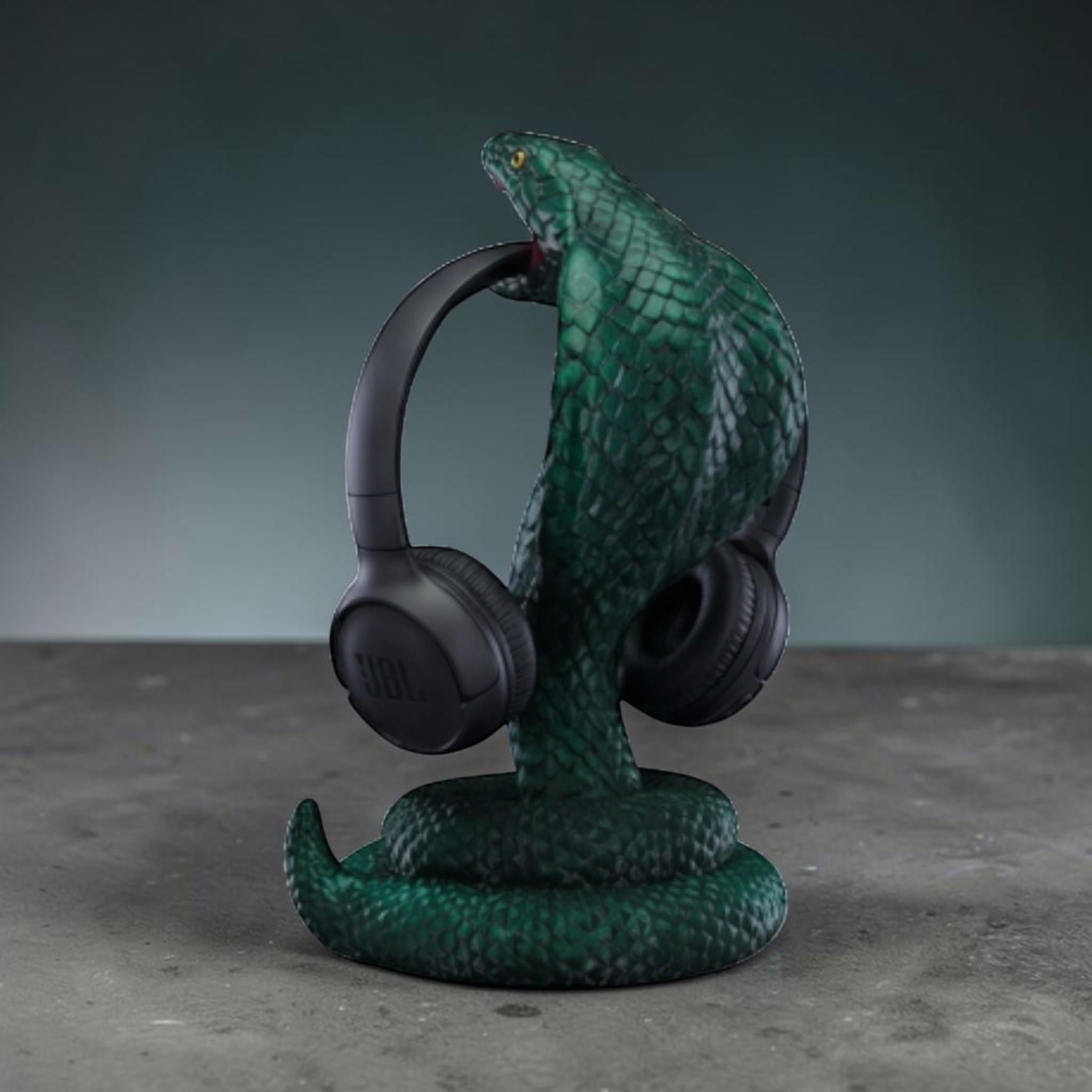 Happy3dWorld metallic green 3D printed cobra snake headphone stand with detailed scales holding black headphones.