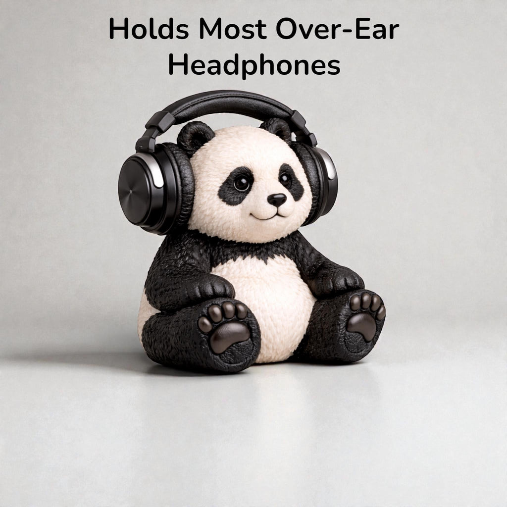 Happy3dWorld panda headphone stand made of black and white bioplastic, holding over-ear gaming headphones on a desk.