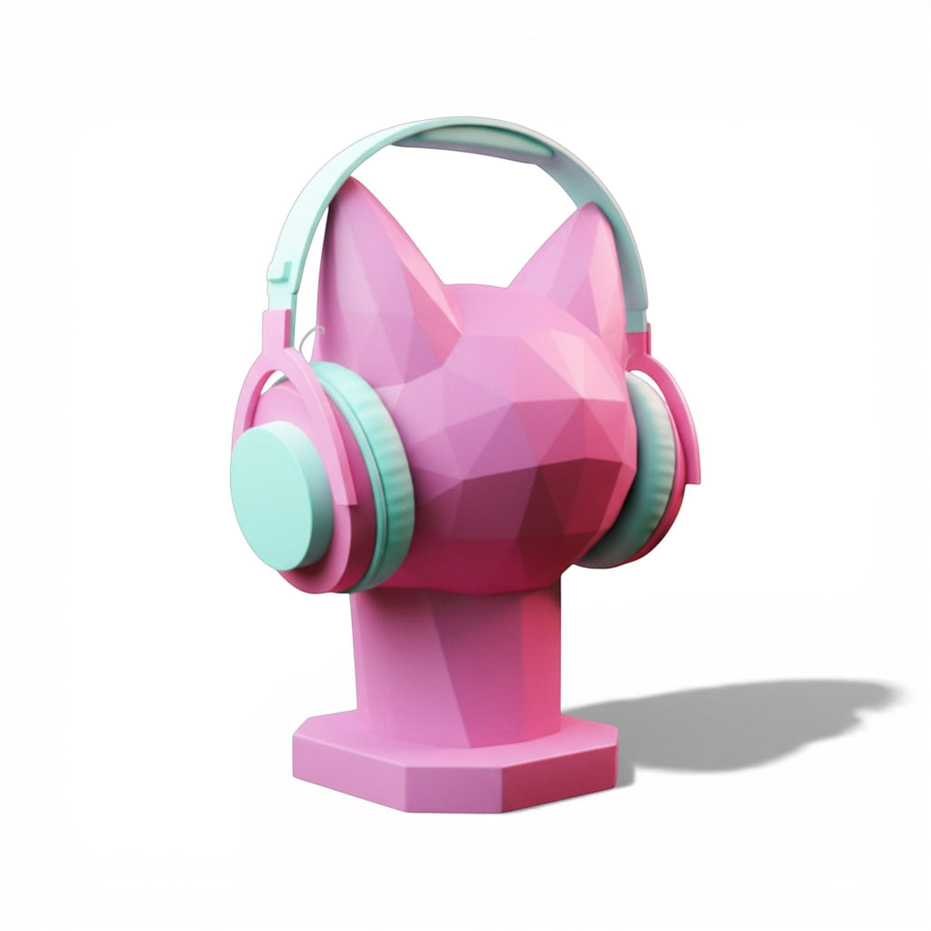 Happy3dWorld pink geometric cat headphone stand with pastel mint and pink over-ear headphones on a white background.
