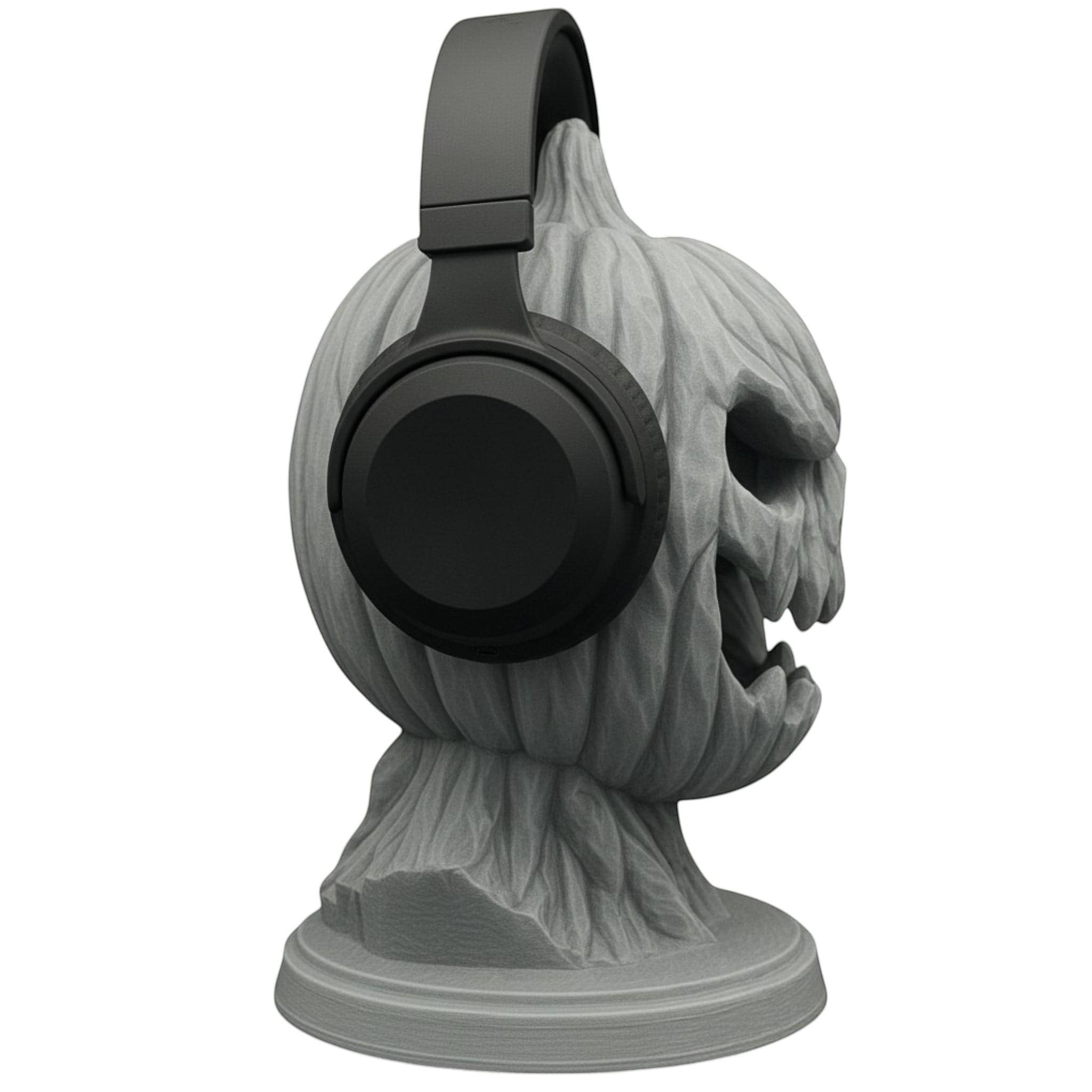 Happy3dWorld matte grey 3D printed pumpkin skull headphone stand with black over-ear headphones on a desk