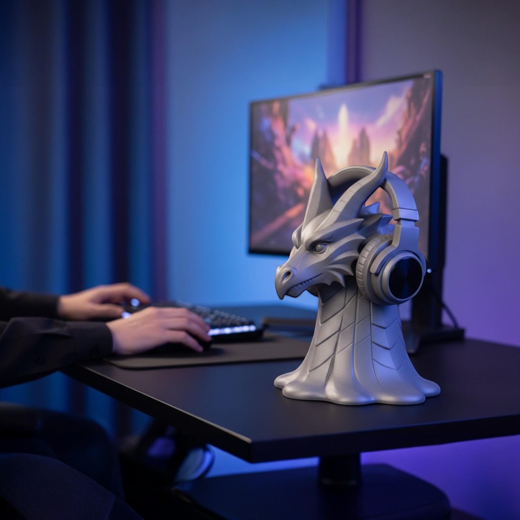Happy3dWorld silver dragon head headphone stand on a gaming desk with a headset resting on its horns