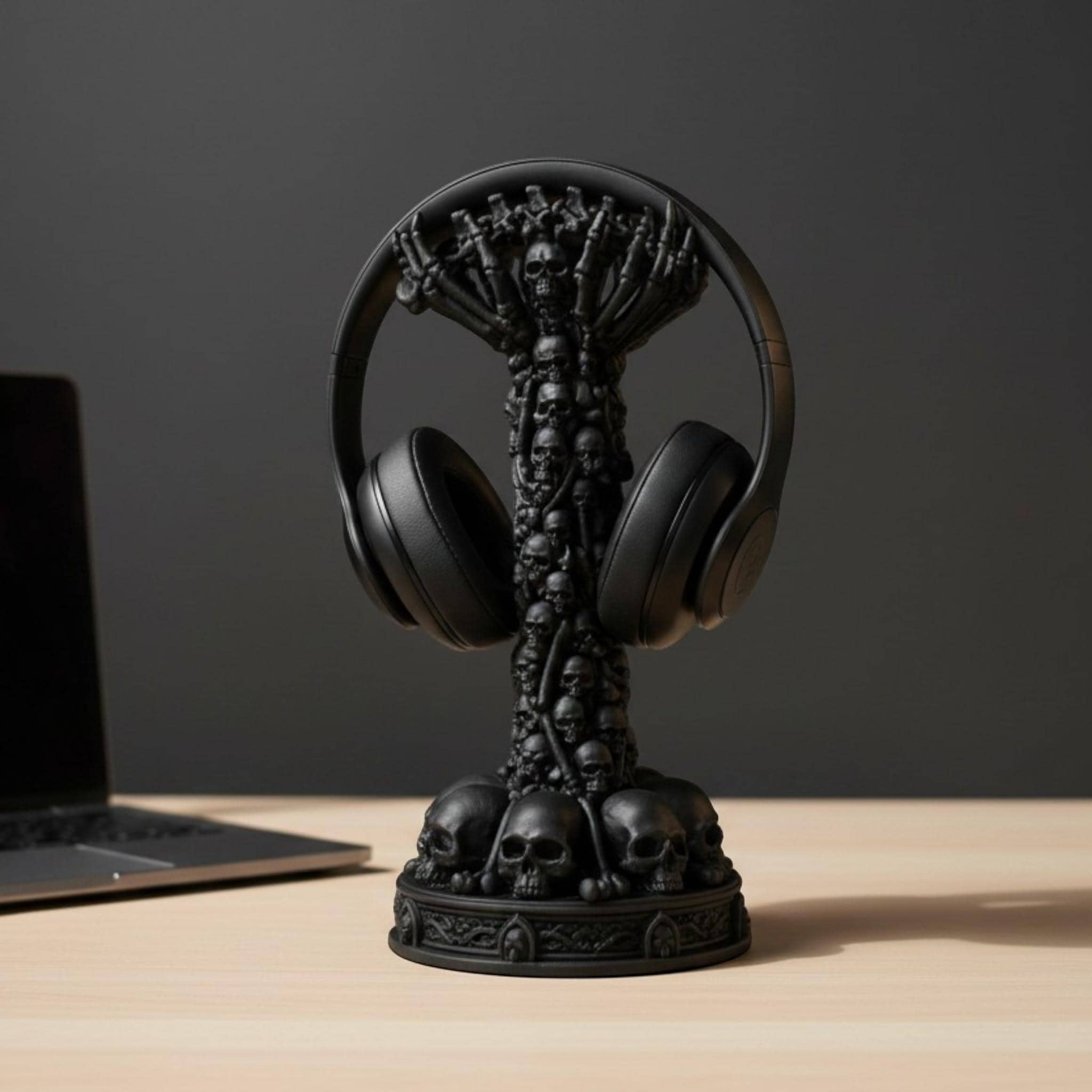 Happy3dWorld matte black skull column headphone stand with intricate skeletal details on a wooden desk