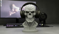 Happy3dWorld grey skull headphone stand with cyberpunk mechanical details displayed on a gaming desk.