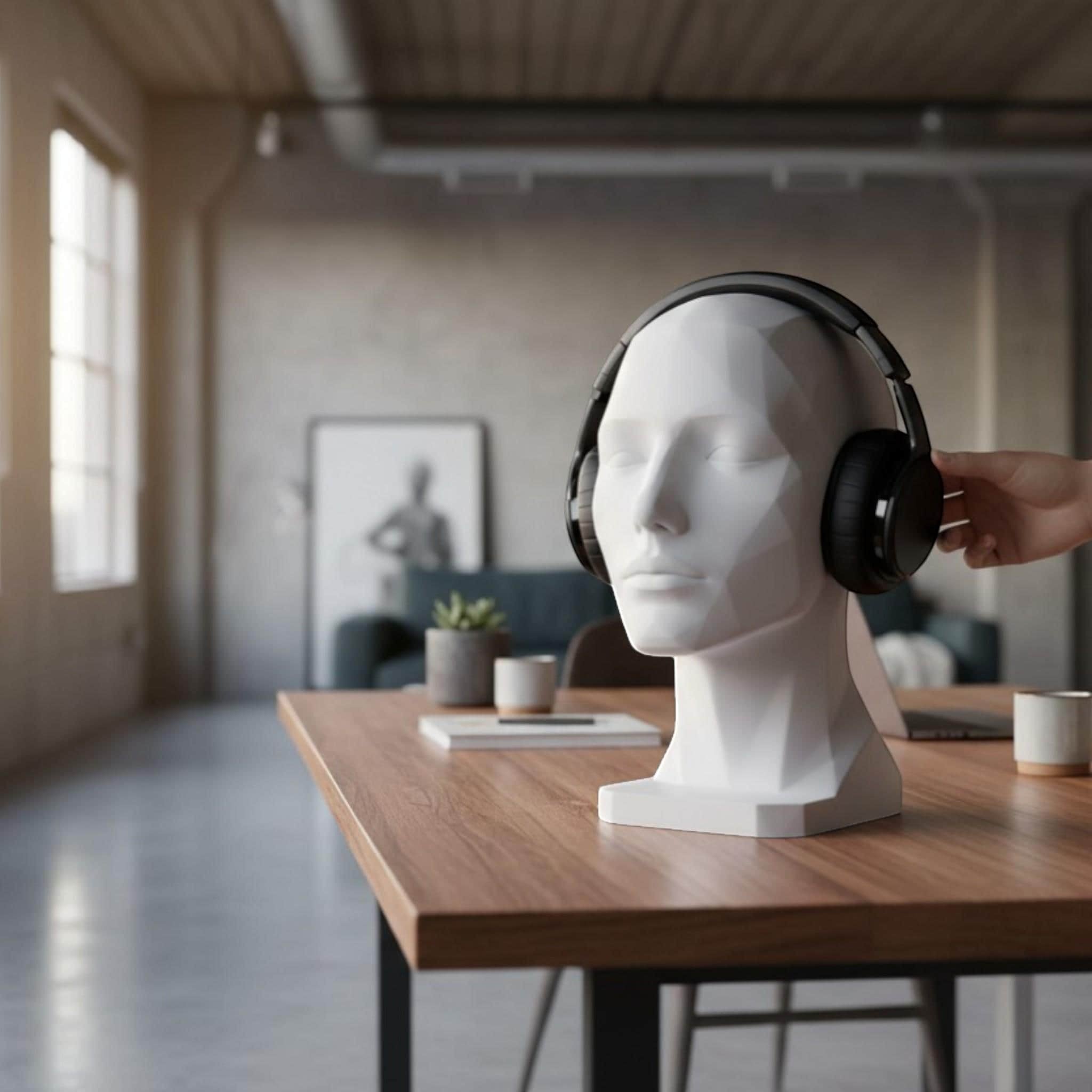 Happy3dWorld white minimalist human bust headphone stand holding black over-ear headset on a modern wooden desk