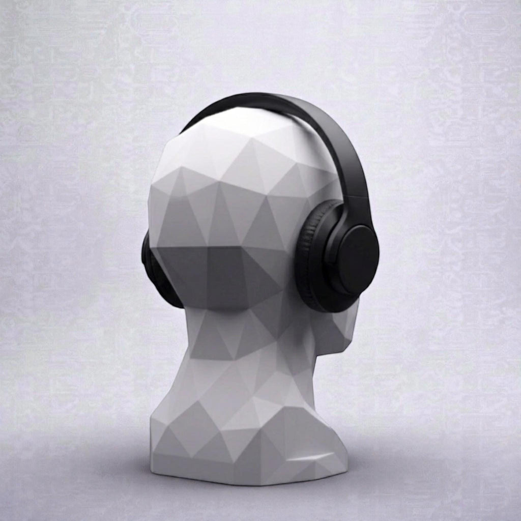 Happy3dWorld white geometric human bust headphone stand displaying black over-ear headphones on a desk