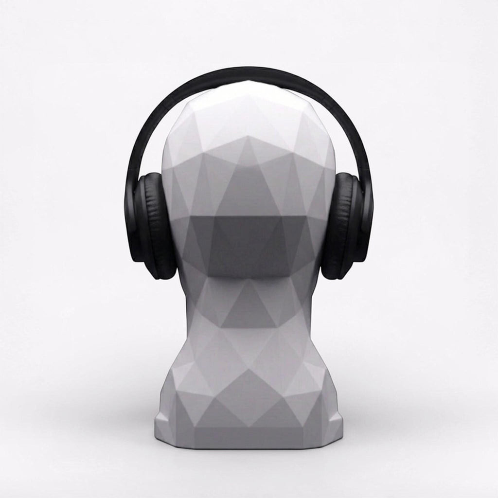 Happy3dWorld white geometric human bust headphone stand displaying black over-ear headphones on a clean white background