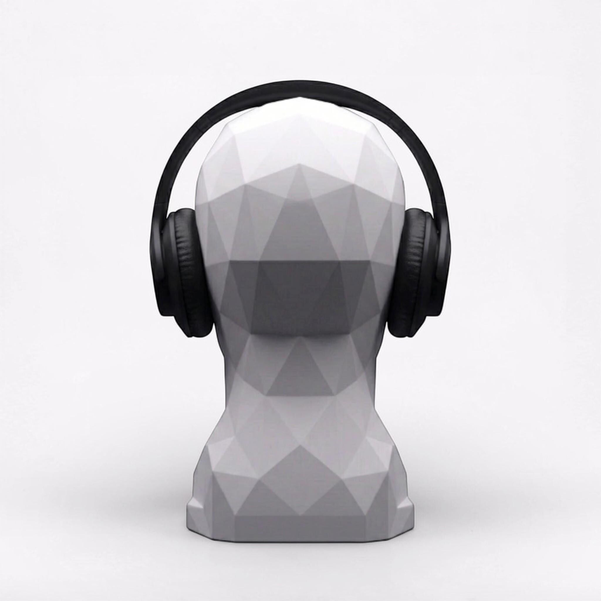 Happy3dWorld white geometric human bust headphone stand displaying black over-ear headphones on a clean white background