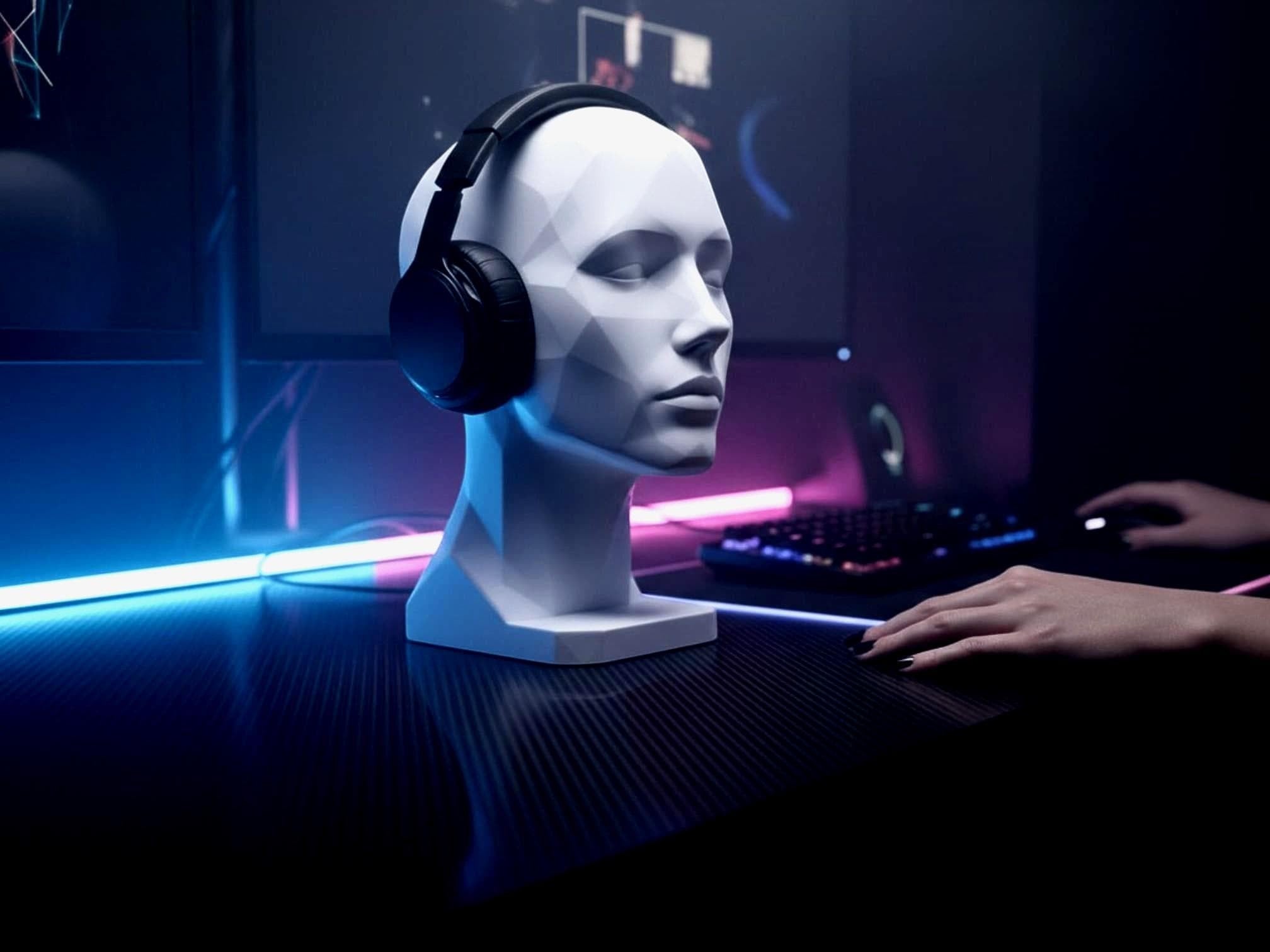Happy3dWorld white geometric human bust headphone stand holding black over-ear headphones on a modern gaming desk.