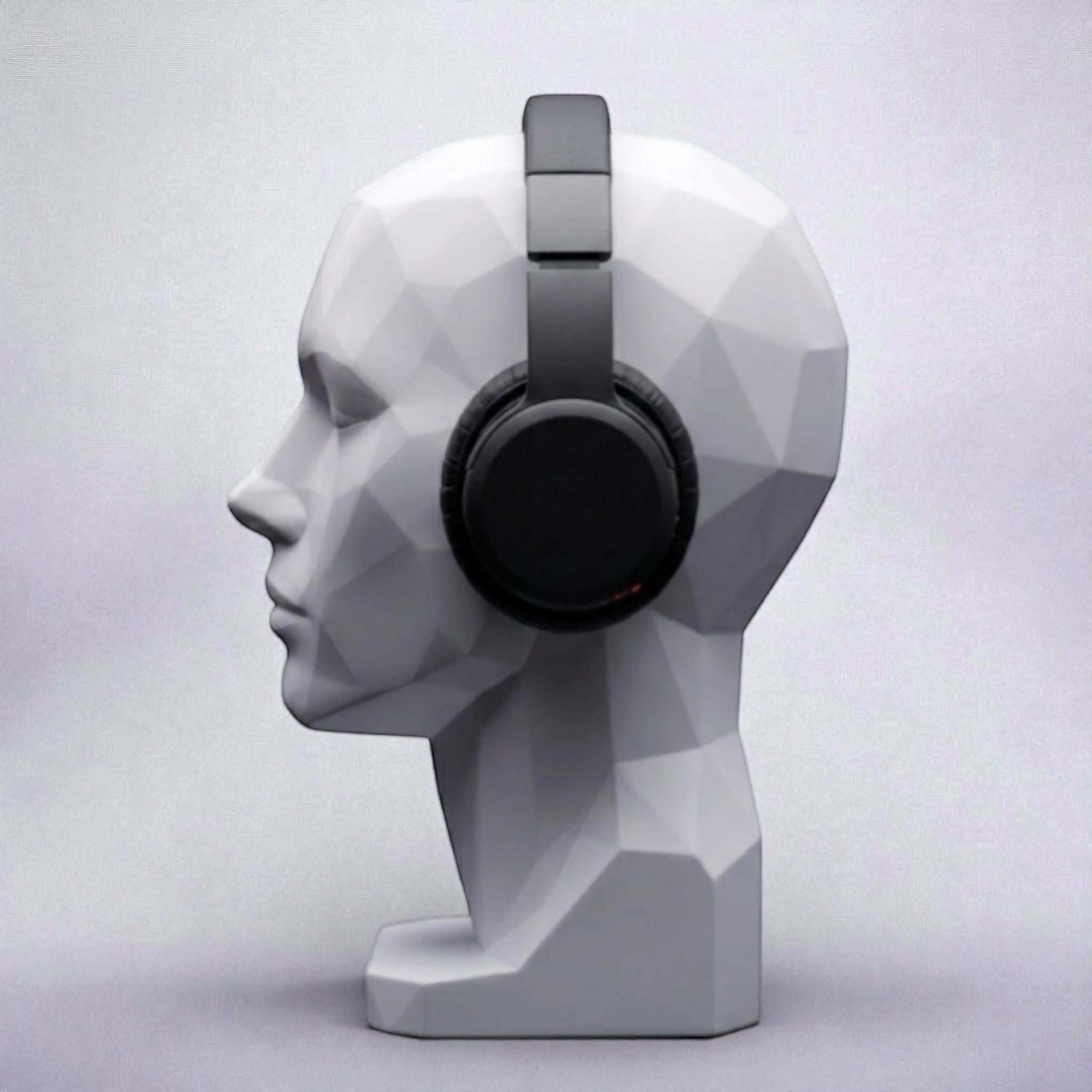 Happy3dWorld white geometric human bust headphone stand displaying black over-ear headphones on a minimalist desk